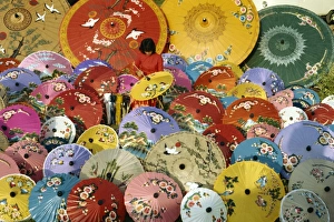 Chiang Mai Prints: Woman painting umbrellas at Bosang in Chiang Mai