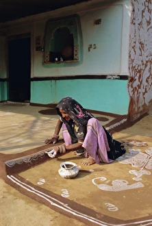 Concentration Prints: Woman painting the wall of a village house
