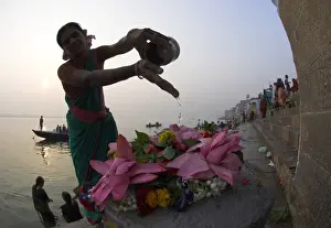 Ghat Prints: Woman pouring water over flowers on an altar as a religious ritual