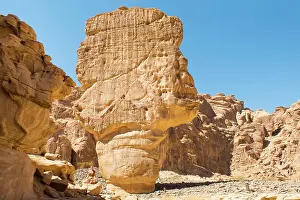 Mindfulness Prints: Woman practising yoga poses among sandstone rock formation in the desert canyons of the Ashar Valley