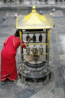 Images Dated 26th July 2007: Woman and prayer wheels, Golden Temple, Patan, Nepal, Asia