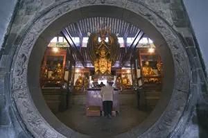 Suzhou Prints: A woman praying in front of an arched entrance at West Garden Buddhist Temple