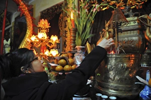 Ha Noi Prints: Woman praying in a Hanoi Buddhist temple, Hanoi, Vietnam, Indochina, Southeast Asia, Asia