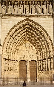 Images Dated 12th May 2008: Woman praying in front of Last Judgment gate, west front, Notre Dame Cathedral