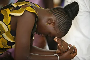 Senegal Prints: Woman praying at mass in Popenguine, Popenguine, Thies, Senegal, West Africa, Africa