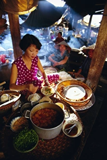 Readying Prints: Woman preparing food at a stall in the market