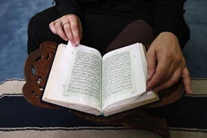 Images Dated 1st May 2008: Woman reading Koran in Jumeirah mosque, Dubai, United Arab Emirates, Middle East