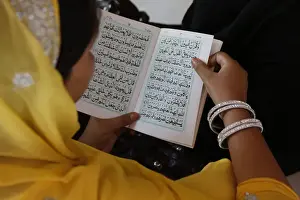 Delhi Prints: Woman reading Kuranic scriptures in Nizamuddin Dergah, Delhi, India, Asia