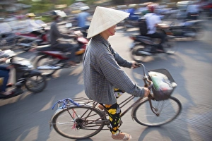 Wearing Prints: Woman riding bicycle, Hue, Thua Thien-Hue, Vietnam, Indochina, Southeast Asia, Asia