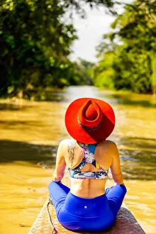 Individuality Prints: Woman searching for wildlife on the Amazon River, Peru, South America