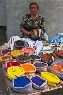 Woman selling colourful spices at market stall, Osh, Kyrgyzstan, Central Asia, Asia