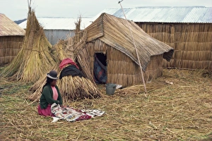 Reed Prints: A woman with her sewing sitting outside her reed house