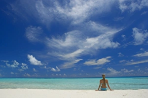 Maldives Prints: Woman sitting on the beach looking out to sea, Maldives, Indian Ocean, Asia