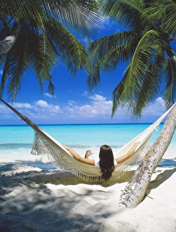 Hammock Prints: Woman sitting in hammock on beach, Maldives, Indian Ocean, Asia