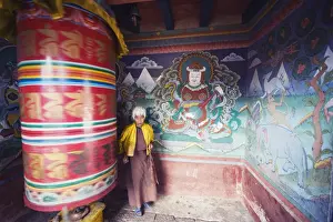 A woman spinning a prayer wheel, Chimi Lhakhang dating from 1499, Temple of the Divine Madman Lama Drukpa Kunley, Punakha