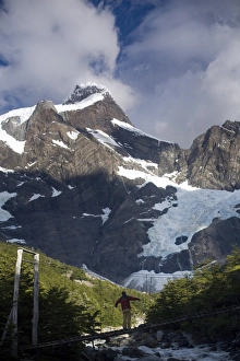 Images Dated 27th January 2008: Woman standing on a suspension bridge over glacial fed river, Torres Del Paine National Park