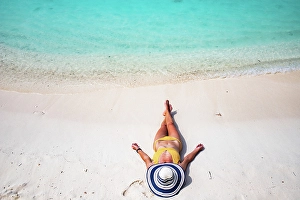 Straw Prints: Woman with straw hat sunbathing on tropical beach, The Maldives, Indian Ocean
