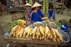 Street Vendor Prints: Woman street vendor selling French bread sandwiches