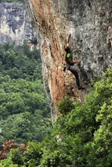 Rock Cliffs Prints: A woman tackles a very difficult climb on limestone cliffs near Siuarana