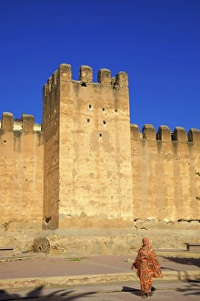 City Walls Prints: Woman in traditional dress with the Old City wall