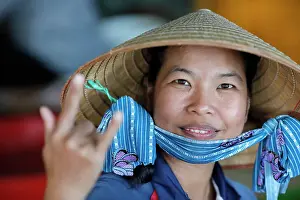 Enjoying Prints: Woman with the traditional Vietnamese conical hat working in a fish factory