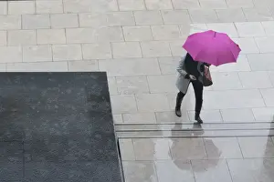 Paving Prints: Woman with umbrella and mobile phone walking up steps to Auckland Art Gallery, Auckland