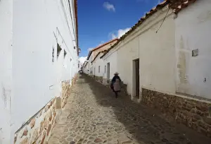 Typically Bolivia Prints: Woman walking along alleyway, Sucre, UNESCO World Heritage Site, Bolivia, South America