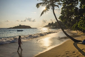 20 24 Years Prints: Woman walking on Mirissa Beach at sunset