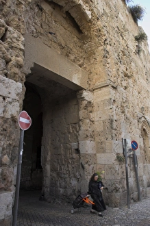 City Gate Prints: Woman walking out of old city through Zion Gate