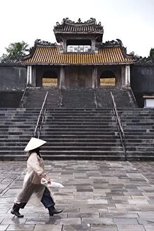 Images Dated 12th April 2007: Woman walking past Tu Duc Mausoleum, Hue, Vietnam, Indochina, Southeast Asia, Asia