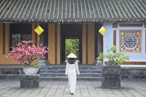 Wearing Prints: Woman wearing Ao Dai dress at Left House inside Citadel