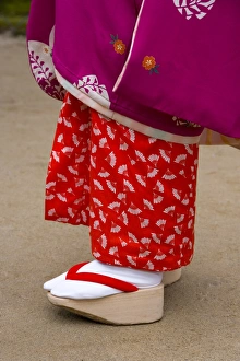 Feminine Prints: Woman wearing traditional Japanese kimono and okobo