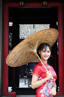 Woman wearing Vietnamese tradition dress called Ao Dai, Taoist temple Woman wearing Vietnamese tradition dress called Ao Dai, Taoist temple
