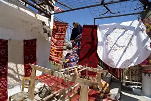 Blanket Prints: Woman weaver selling her blankets in village near Lasithi Plateau