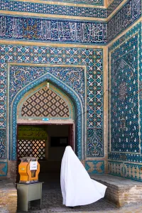 Typically Iranian Prints: Woman in white chador enters Jameh Mosque, Varzaneh, Iran, Middle East