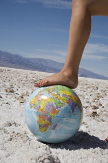 Arid Landscape Prints: Womans foot on globe