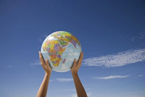 Lifting Prints: Womans hands holding globe