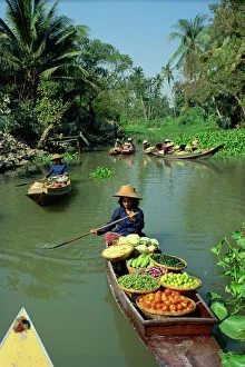 Women in canoes on way to floating market