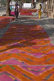 Women laying newly printed dupattas out to dry in the street, Jodhpur, Rajasthan