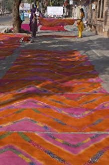 Women laying newly printed dupattas out to dry in the street, Jodhpur, Rajasthan Women laying newly printed dupattas out to dry in the street, Jodhpur, Rajasthan
