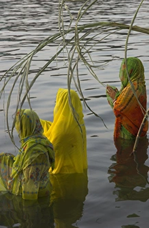 Sari Prints: Three women pilgrims in saris making Puja celebration