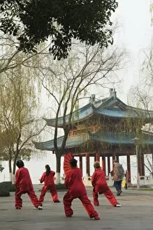 Images Dated 7th January 2008: Women practising tai chi in front of a pavilion on West Lake, Hangzhou