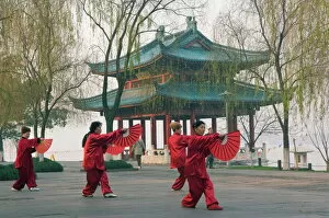 Images Dated 7th January 2008: Women practising tai chi in front of a pavilion on West Lake, Hangzhou