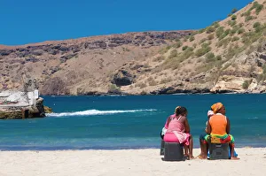 Cape Verde Prints: Two women sitting on the sandy beach talking, Tarrafal, Santiago, Cabo Verde, Africa