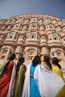 Women in traditional dress standing in front of the Palace of the Winds (Hawa Mahal), Jaipur, Rajasthan, India, Asia