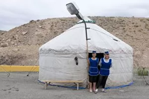 Images Dated 4th September 2009: Women in front of a traditional yurt acting as a restaurant with a street lamp waiting for
