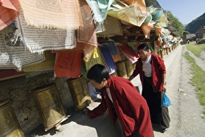 Spinning Prints: Two women turning prayer wheels, Tagong temple, Tagong, Sichuan, China, Asia