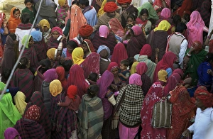 Women from villages crowd the street at the Camel Fair