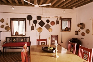 Wood beamed ceiling and kitchen utensils on wall in