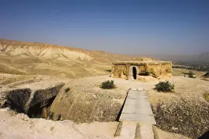 Afgani Prints: Wooden bridge across chasm leading to Buddhist stupa carved out of rock